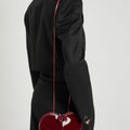 ALAÏA Le Coeur patent leather cross-body bag burgundy
